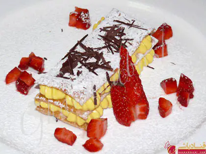 شیرینی ناپلئونی چیست - شیرینی ناپلئونی ایتالیایی پر شده با خامه قنادی ، تزئین شده با توت فرنگی و پودر قند